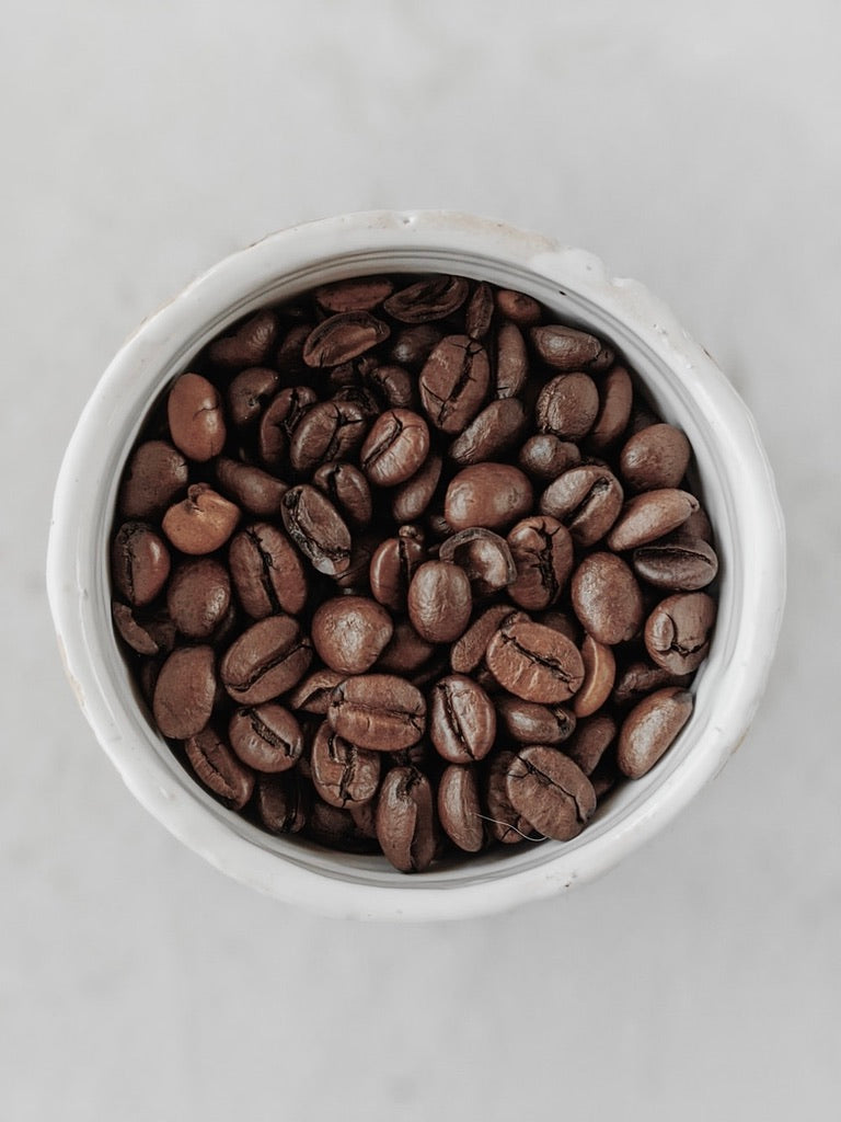 Medium roasted coffee beans in a cup